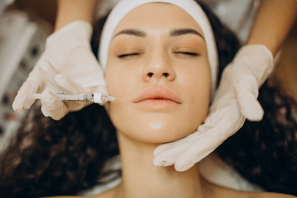 Woman making injections cosmetologist